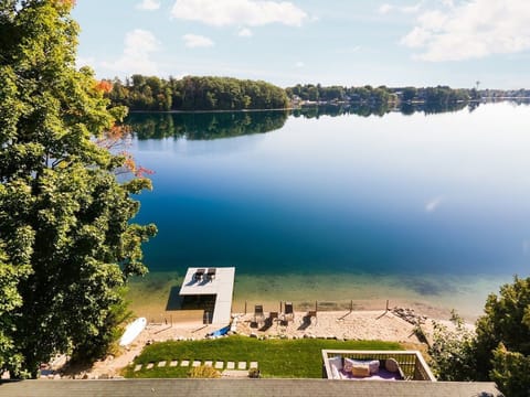 Private **lakefront with sandy beach and dock**, perfect for swimming, relaxing, and enjoying peaceful water views.
