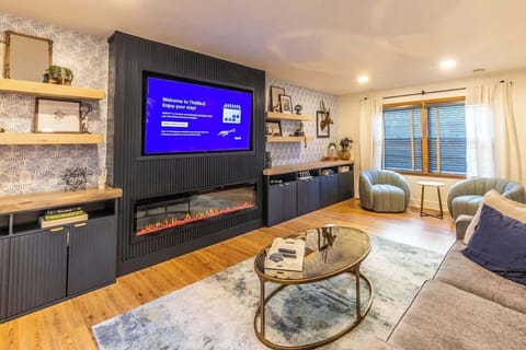 Sit back in the bright open-concept living room with a comfy sofa, Smart TV, and electric fireplace, creating your Lincoln family hangout.