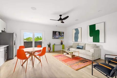 Inviting living area with vibrant accents, comfortable seating, a Smart TV, and a fully equipped kitchen in view, creating an easy flow for relaxing, dining, and gathering. (3rd Floor)