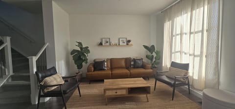 Cozy living room with comfortable seating, warm ambiance, and a welcoming space 