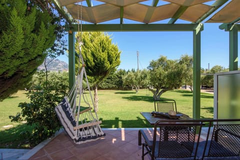 Shaded Outdoor Pergola with Seating and Garden Views