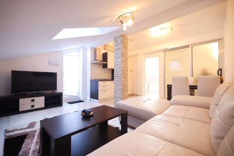 Comfort Apartment, Partial Sea View | Living area | 100-cm Smart TV with satellite channels