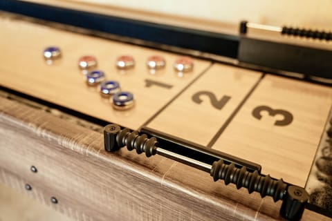 Challenge friends to a classic game of shuffleboard in your private game room, complete with scoring zones and smooth playing surface.