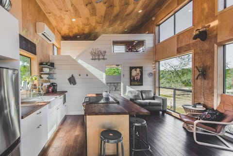 Soaring wood ceilings and floor-to-ceiling windows let in natural light and forest views.