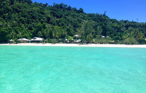Beach nearby, white sand, beach umbrellas, beach towels