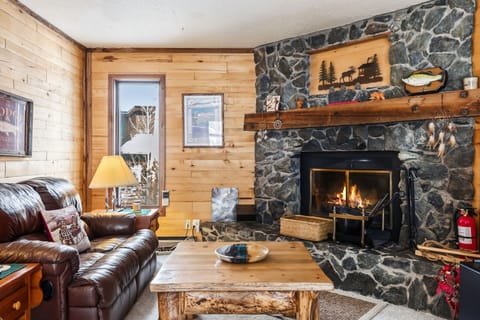 Cozy up in your rustic retreat with crackling flames and leather seating perfect for mountain evenings.