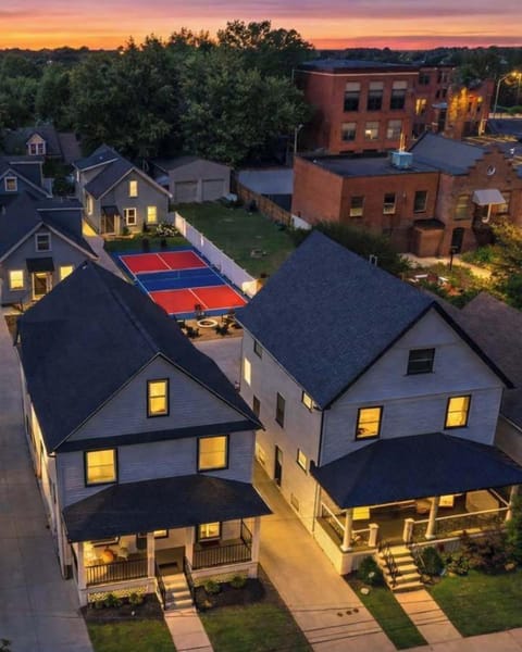 Aerial view showcasing three modern homes and shared outdoor amenities perfect for large groups, family reunions, and special gatherings.
