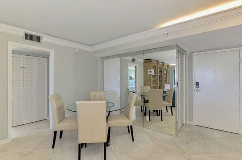 Your elegant dining space features a sleek glass table and plush seating, perfect for memorable meals together.