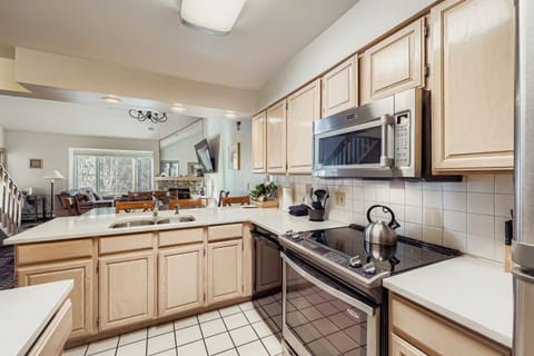 Step into your spacious kitchen with bright countertops, full appliances, and warm wood cabinets where you'll love cooking meals.