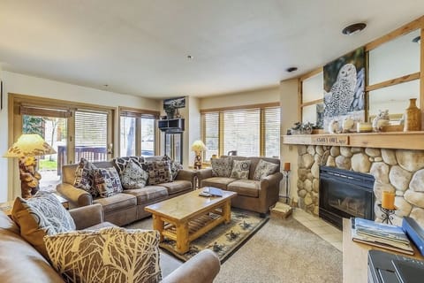 Settle into your mountain-style living room where plush sofas invite relaxation by the stone fireplace's warm glow.