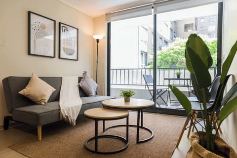 Relax in this stylish living room with balcony access, perfect for enjoying the view and fresh air.