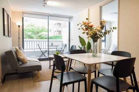 Bright and cozy living area with balcony access, perfect for relaxing or dining with a view.