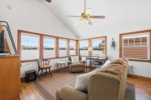 Vaulted ceilings, warm wood trim, and lake-facing windows — the living room feels open and easy from the moment you walk in.