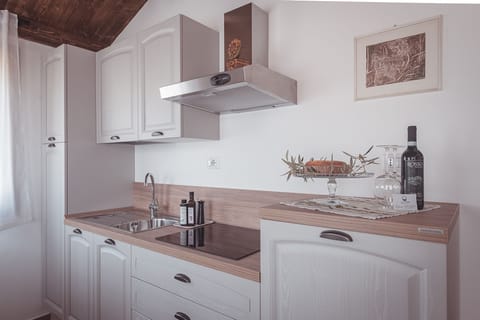 Family Condo, 1 Bedroom, Ground Floor (PIOPPO) | Private kitchen | Full-size fridge, stovetop, cookware/dishes/utensils, dining tables