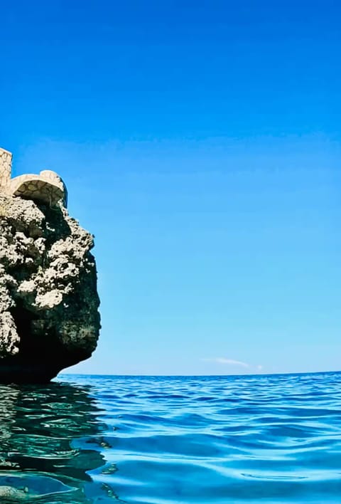 summer, outdoor, body of water, rock formation at property, cliff side access
