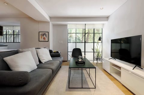 Cozy living room with natural light and Smart TV