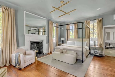 Bedroom #1: Bright, elegant, and inviting, this king suite offers a plush bed, cozy sofa, TV, and plenty of natural light for a truly relaxing stay.