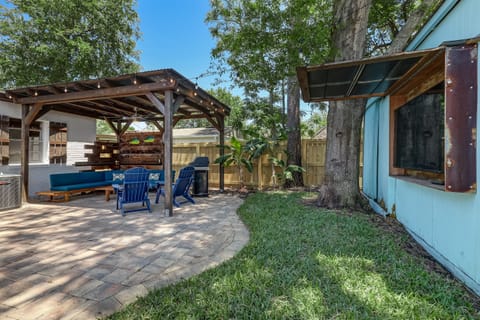 Spacious backyard patio with pergola seating area and room to gather outdoors.