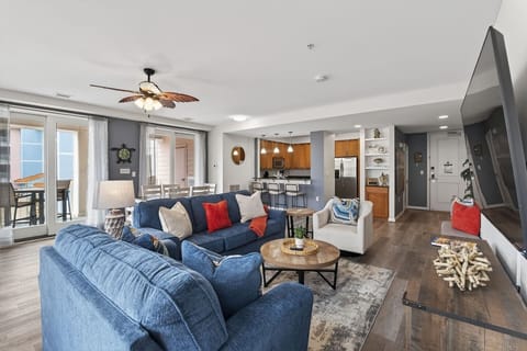 Bright, modern living space with stylish coastal décor and open flow into the kitchen—perfect for relaxing and entertaining.