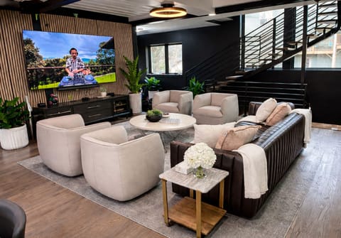 Incredible Living Room with Stunning Leather Sofa, Leather Swivel Chairs, and High Definition 85" Smart TV with Vizio Sound System.