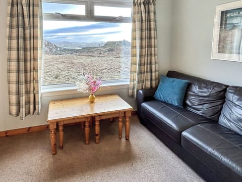 Relax in our cosy sitting room with beautiful sea views | Orchid Cottage - Cathair Dhubh Estate, Clachtoll, near Lochinver