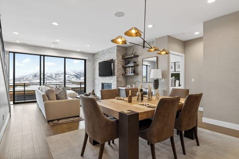 Dinner with a view—gather at the statement dining table, then unwind by the fireplace as the mountains fill the windows.