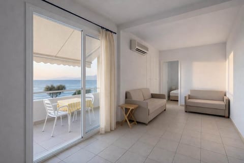 Bright open-plan living space opening onto a private balcony with beautiful sea views.