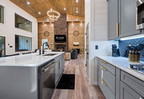 The long kitchen layout provides plenty of counter space and storage, giving everyone room to help with meals or snacks.