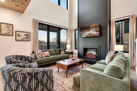Bright, airy space with stunning views, plush seating, and a stylish fireplace for ambiance!