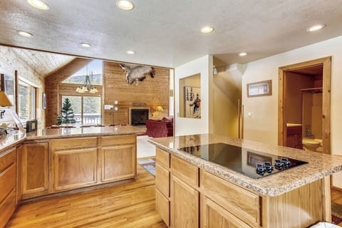 Your fully equipped kitchen features granite counters and gleaming appliances, perfect for creating memorable meals during your mountain getaway.