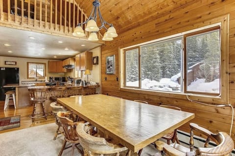 Gather around this spacious dining table for memorable meals, with your fully-equipped kitchen nearby and snowy mountain views beyond the windows.