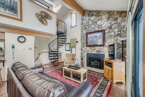 Relax in your cozy living room with leather seating, stone fireplace, and spiral stairs leading to your private loft space.