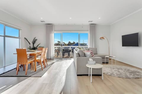 Move seamlessly through open-plan living, where lounge and dining connect in a bright, social space designed for gathering.