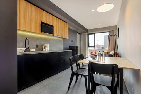 Modern open kitchen with sleek finishes and dining area.
