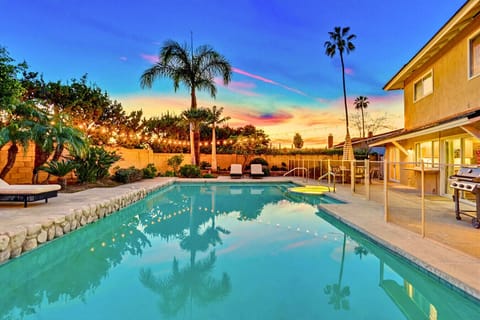Sparkling backyard pool at sunset w/ lounge seating & palm-lined ambiance for relaxing evenings outdoors