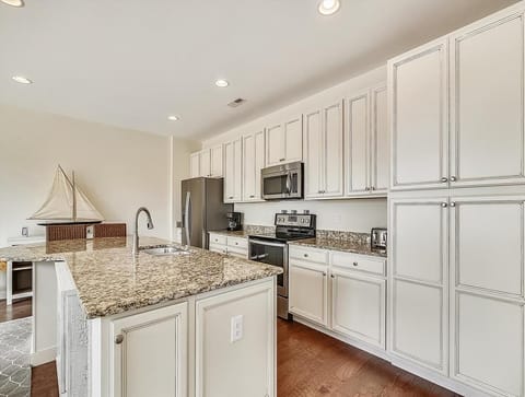 Savor the elegance of this kitchen, featuring beautiful granite countertops and ample storage.