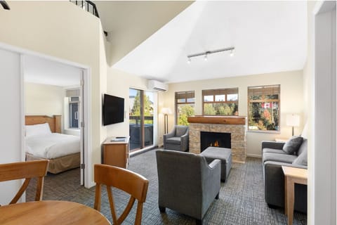 Lounge together in airy seating with a glowing fire nearby.