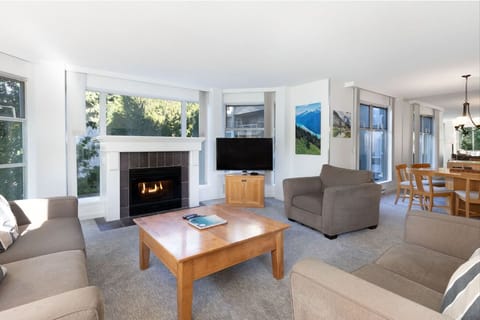 Unwind by the cozy fireplace in a sunlit lounge.