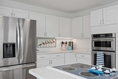 The seamless transition between the living room and kitchen ensures that entertaining becomes effortlessly enjoyable.