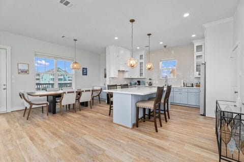 Large open kitchen and dining area ideal for family gatherings at Galveston beach house rental.