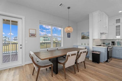 Dining space with natural light and coastal style furnishings in Galveston TX waterfront vacation home.