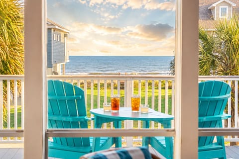Covered upper deck with comfortable Adirondack seating and beautiful Gulf views. Enjoy morning coffee or sunset relaxation from this elevated outdoor living space near Galveston beaches.