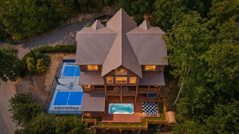 Private mountain playground featuring a spacious sports court with basketball and pickleball, a heated pool, multiple hot tubs, sauna, glow in the dark putt-putt course, oversized outdoor chess set, and breathtaking Smoky Mountain views.