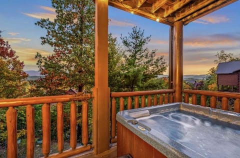 An intimate covered balcony retreat with a private hot tub overlooking layers of fall-colored mountain ridges. Uninterrupted views create a secluded escape designed for relaxation after a day of exploring the Smokies.
