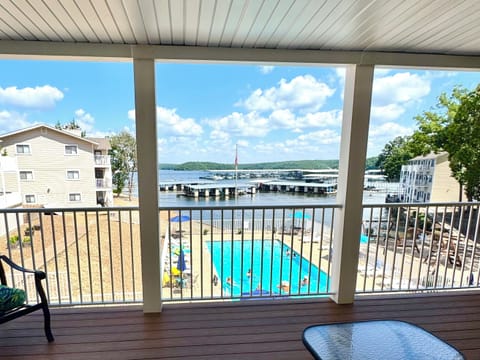Covered porch overlooking the pool and lake