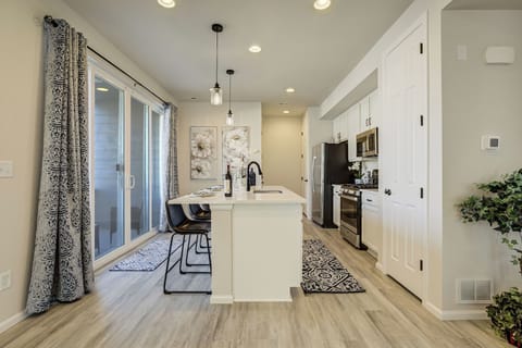 The kitchen is fully stocked and equipped with stainless steel appliances, quartz countertops.