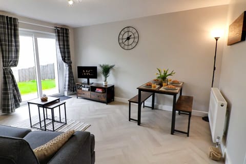 Step into a bright and welcoming living space designed for comfort after a long day. Relax on the sofa, enjoy a film on the Smart TV, or unwind with the patio doors open to the garden.