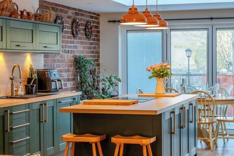 A bright open-plan kitchen and lounge featuring a central island, perfect for socialising, sharing meals, and enjoying relaxed moments together.