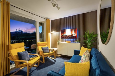 Double patio doors lead out the the balcony overlooking the treetops that surround the lake