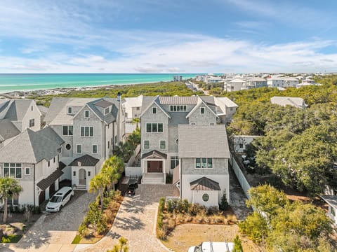 Stunning beachfront property nestled among coastal homes with pristine turquoise waters and sugar-white sand beaches just steps away.